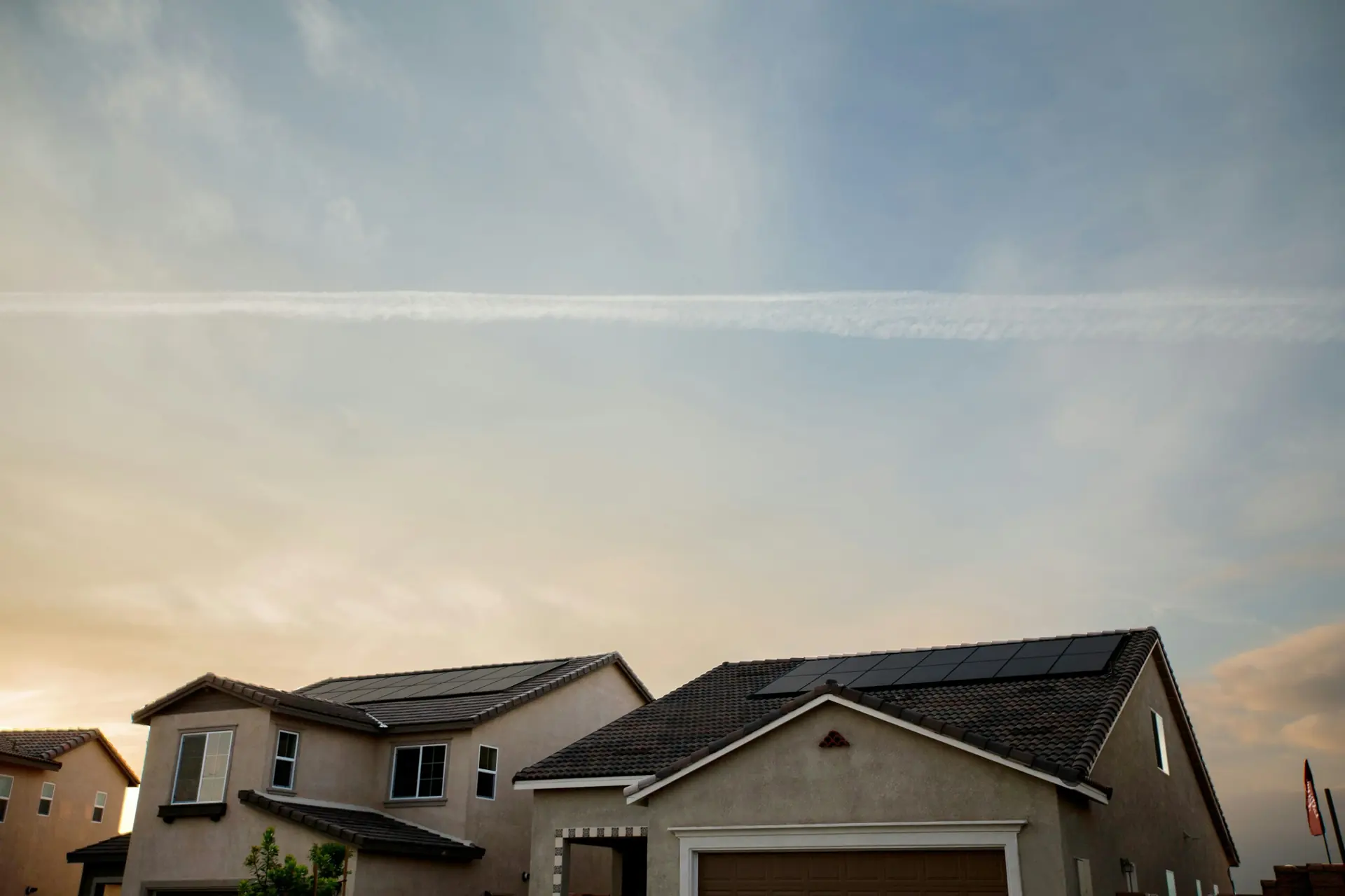 Homes with rooftop solar panels at dusk